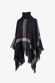 Navy plaid turtleneck cape with fringe detail and textured acrylic knit.