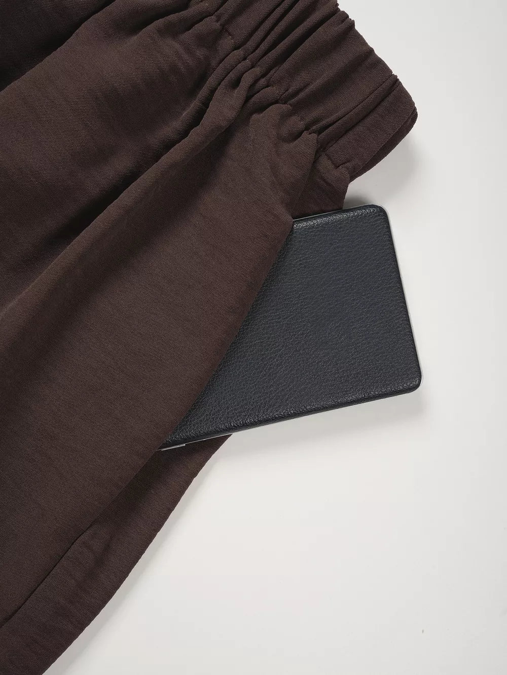 Chocolate wide-leg pants with elastic waistband and side pocket detail.