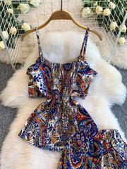 Chic cami and wide-leg pant set in indigo with a colorful paisley print and smocked bodice.