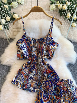 Chic cami and wide-leg pant set in indigo with a colorful paisley print and smocked bodice.