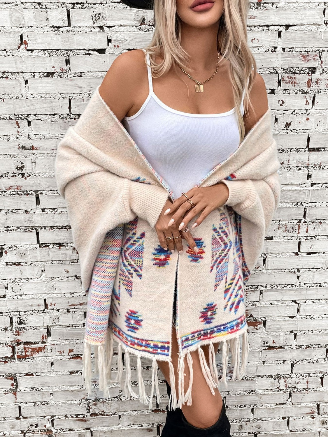 Cream Aztec fringe knit cardigan with colorful geometric pattern and open front.