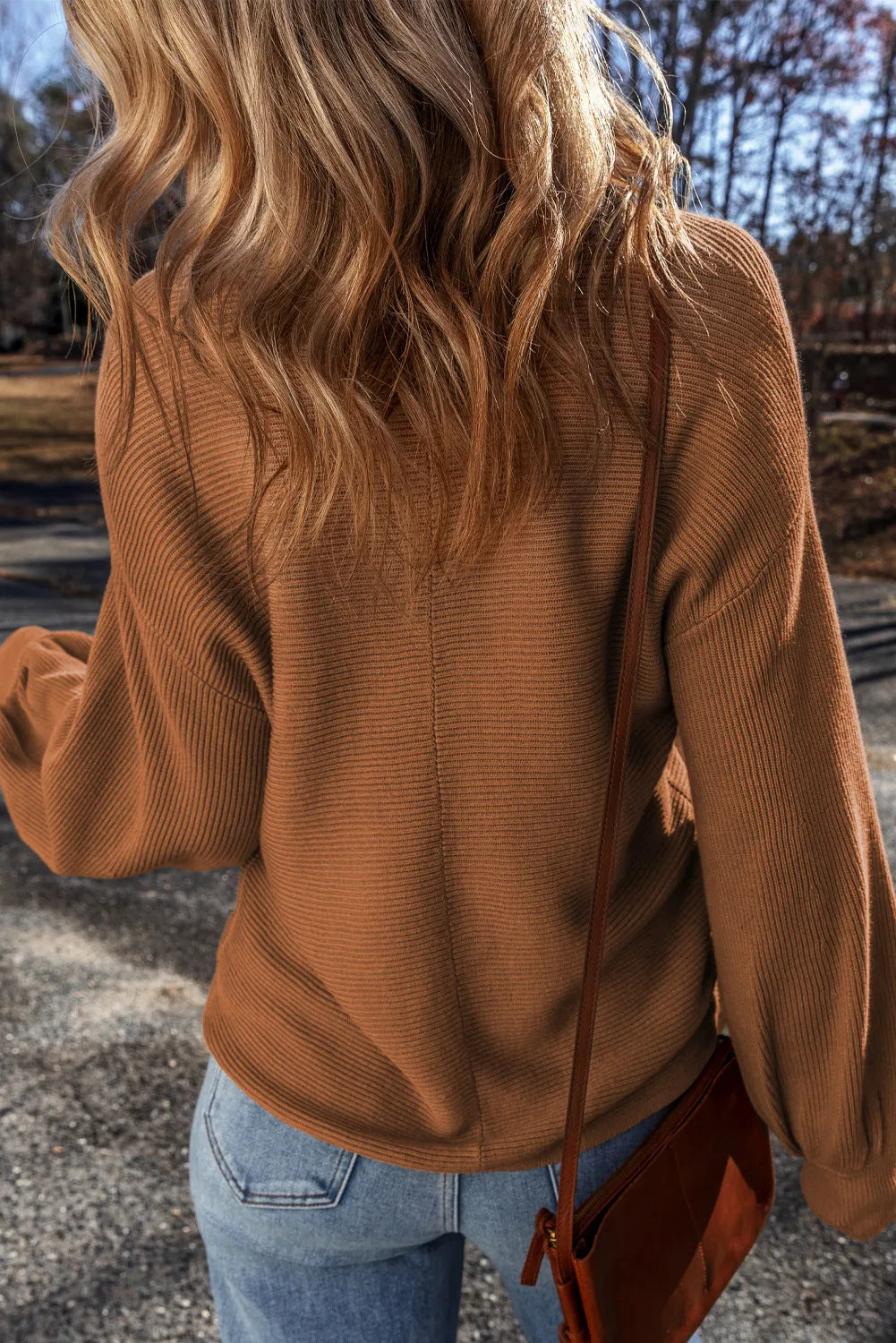 Brown ribbed knit pullover sweater with balloon sleeves and a casual fit.