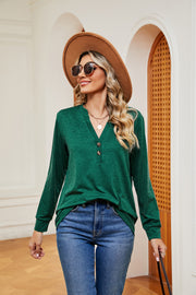 Dark green henley long sleeve top with button detail and v-neck