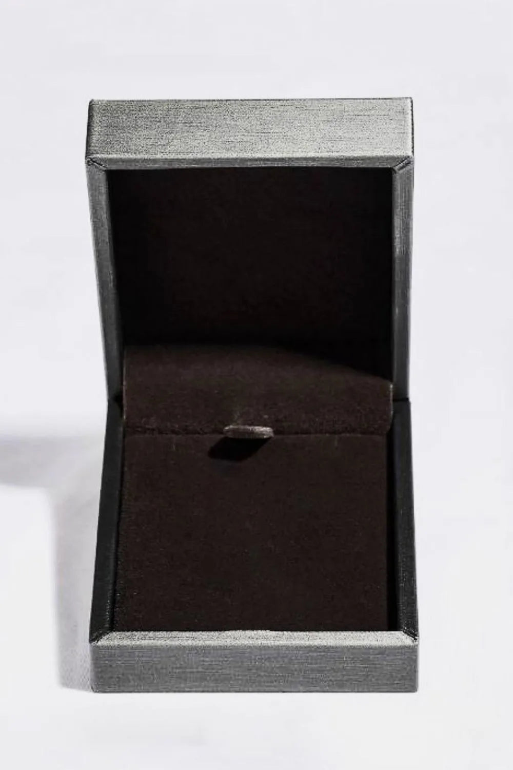 Silver jewelry box with dark brown velvet lining and clasp.