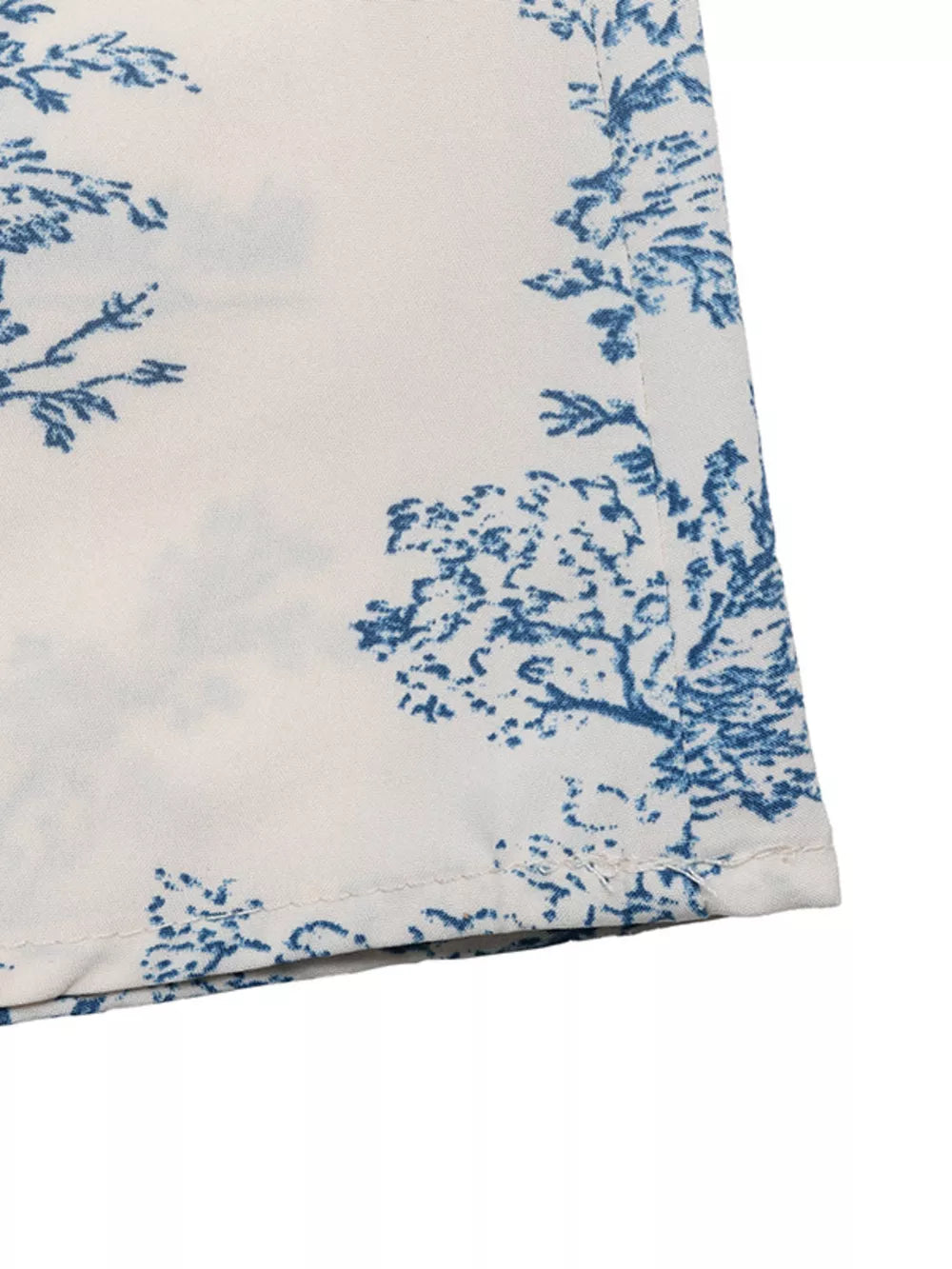Midi dress with blue toile print on white fabric, V-neck, a-line cut.