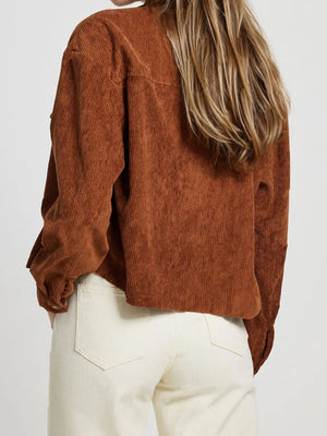 Brown corduroy utility jacket with buttoned cuffs and patch pockets.