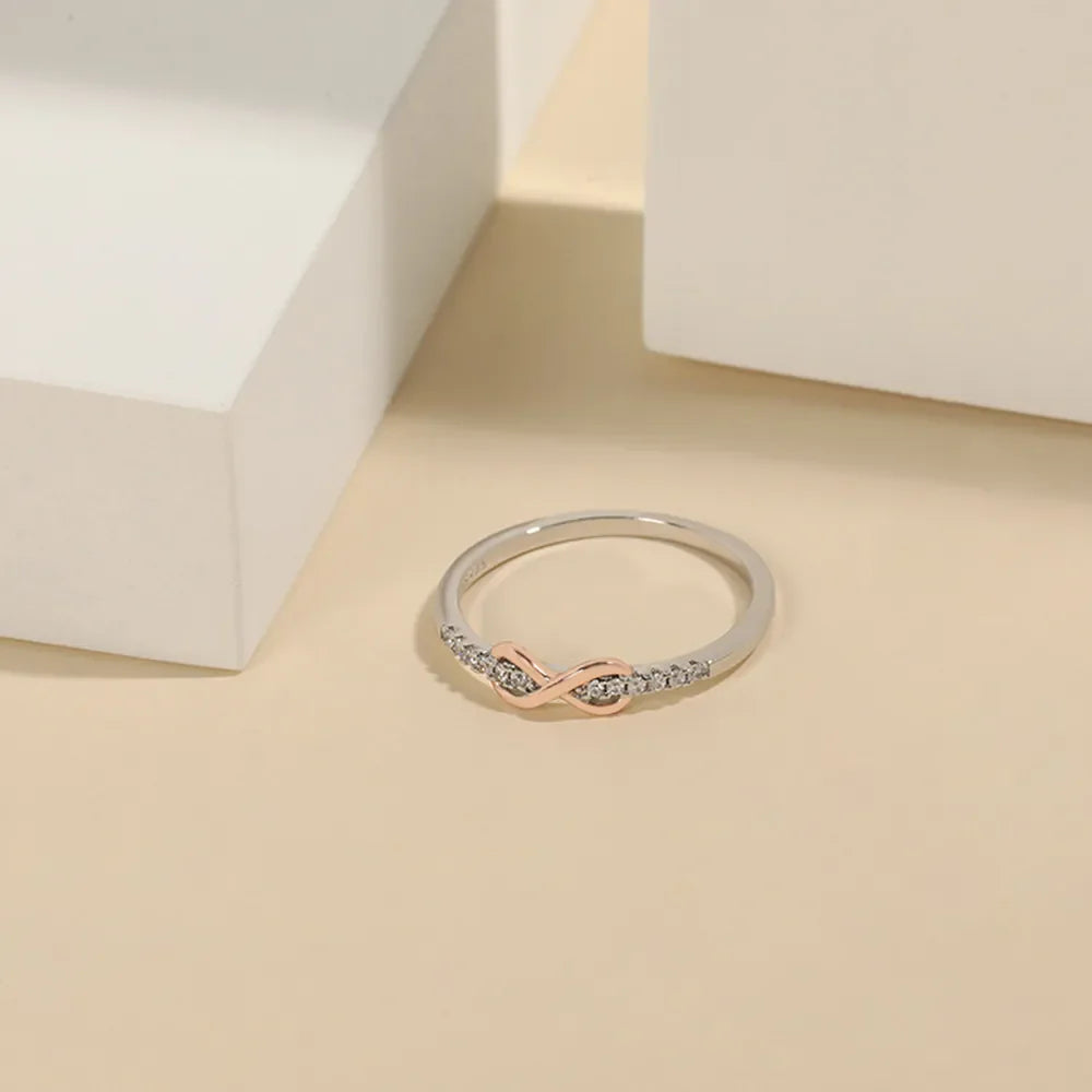 Infinity knot ring with blush pink and diamonds on silver band