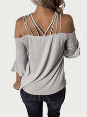Light gray blouson top with strappy shoulders and flared sleeves.