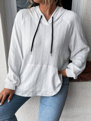 White textured knit raglan hoodie with black drawstrings and a kangaroo pocket.