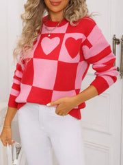 Red and blush pink checkerboard knit sweater with heart details.