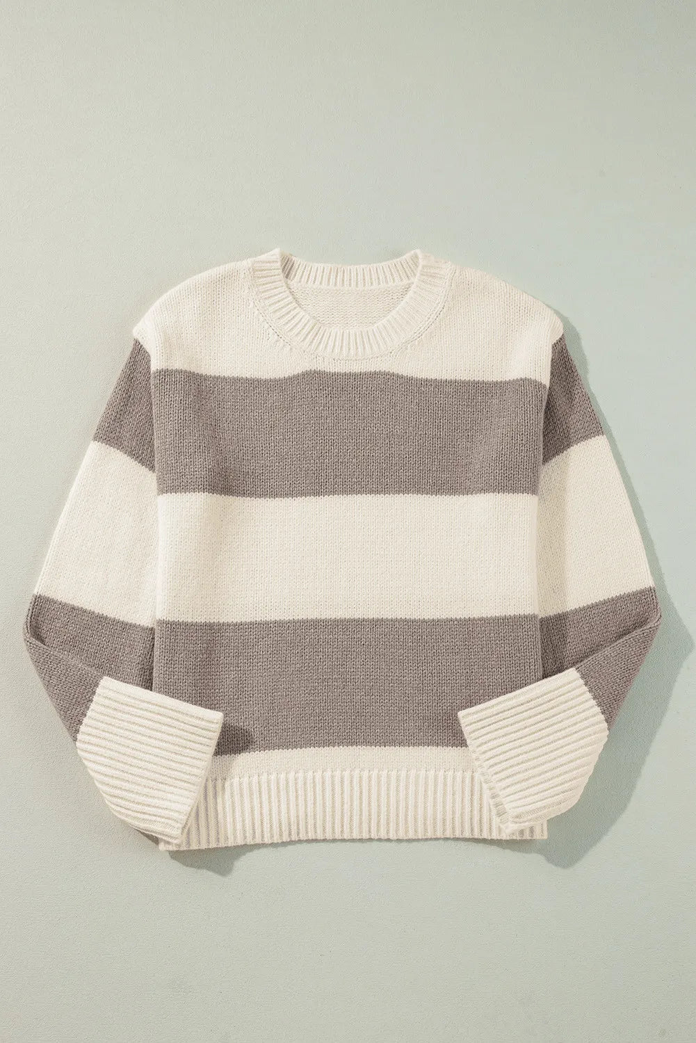 Relaxed knit sweater with bold horizontal stripes in cream and mocha. Acrylic blend.