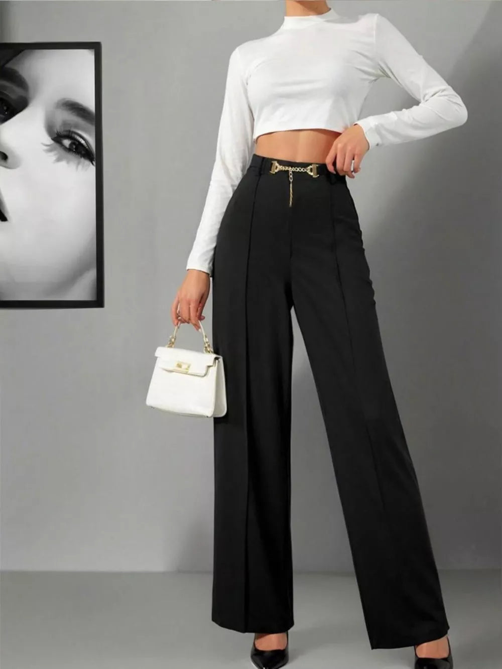 Black wide-leg high-waist maternity trousers with gold chain detail at the waist.