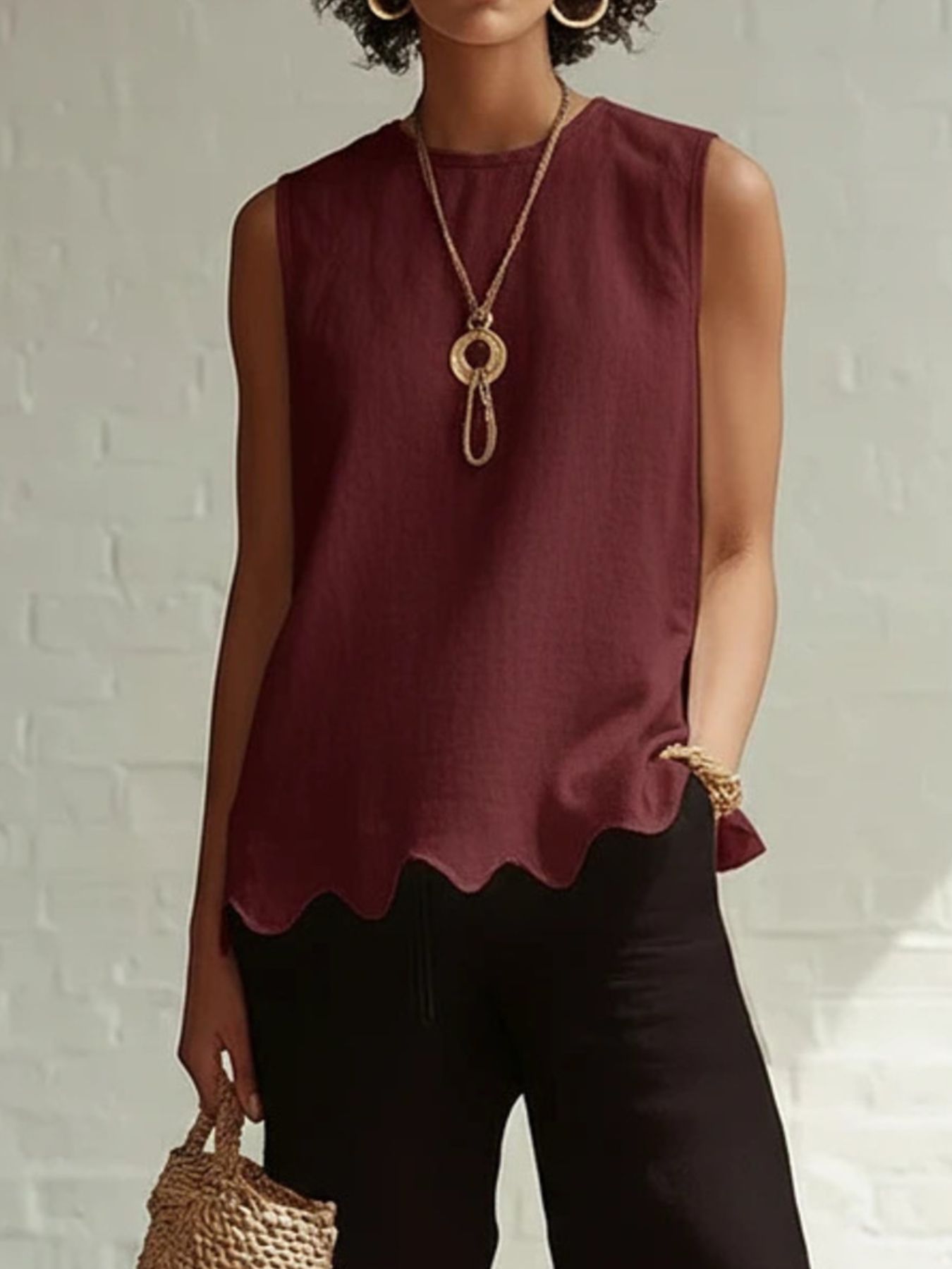Wine red sleeveless tank top with scalloped hem detail.