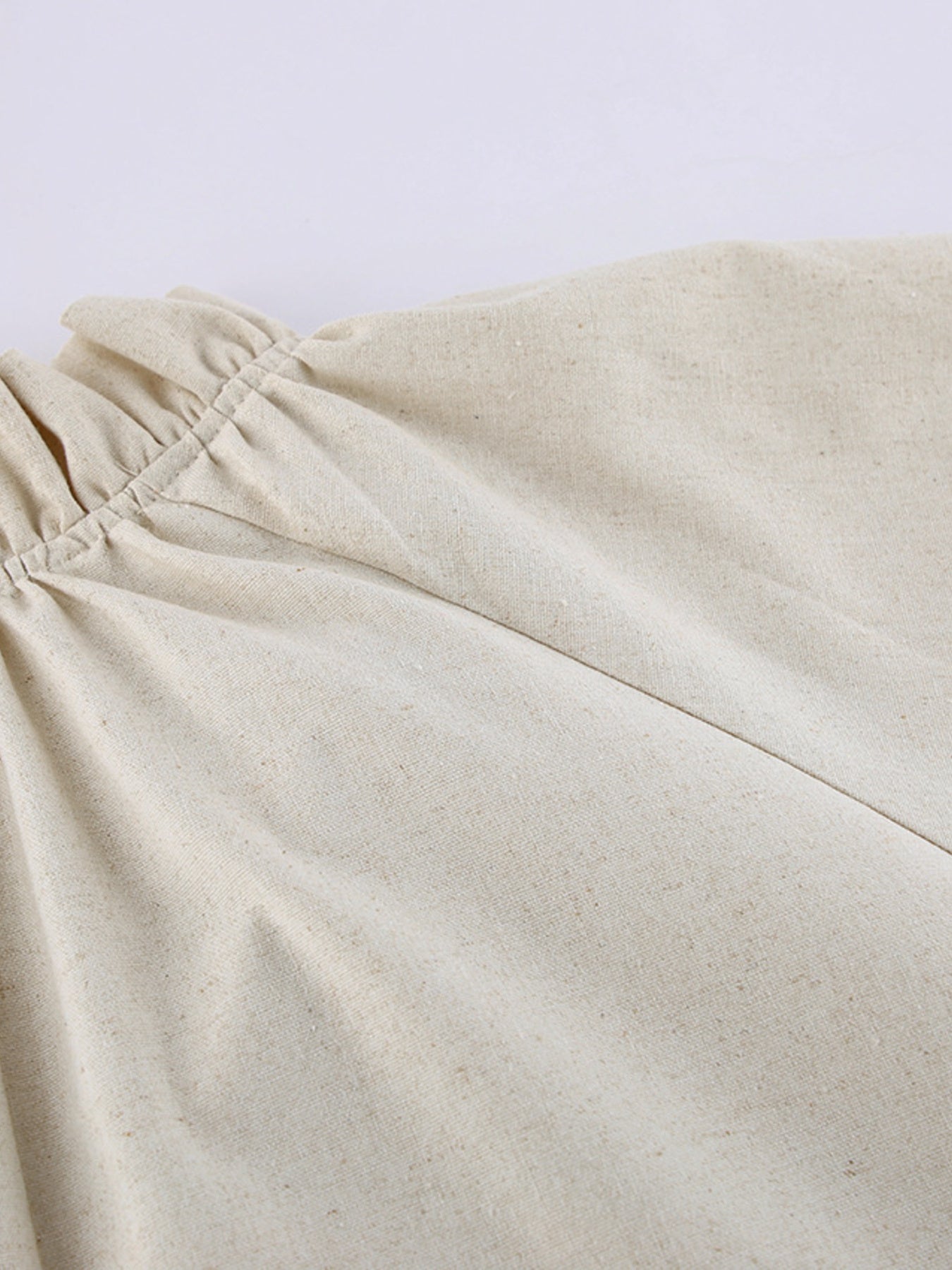 Beige cotton maxi dress with ruffled tie neck detail