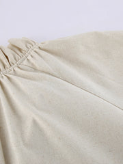 Beige cotton maxi dress with ruffled tie neck detail