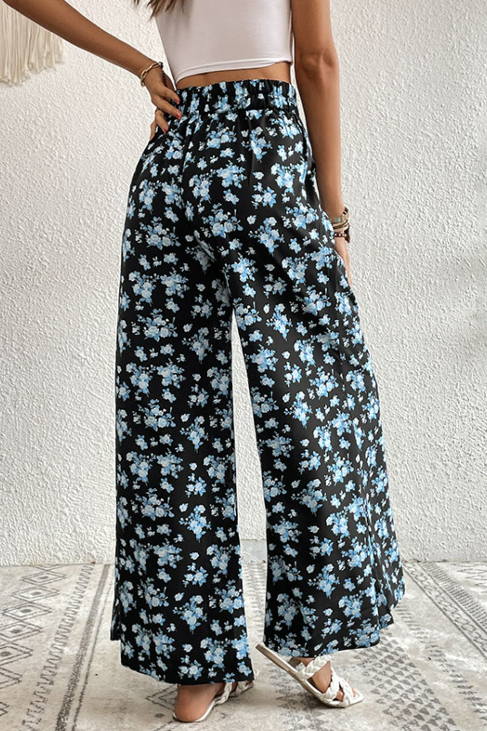 Midnight floral palazzo trousers with a black base and blue floral print.