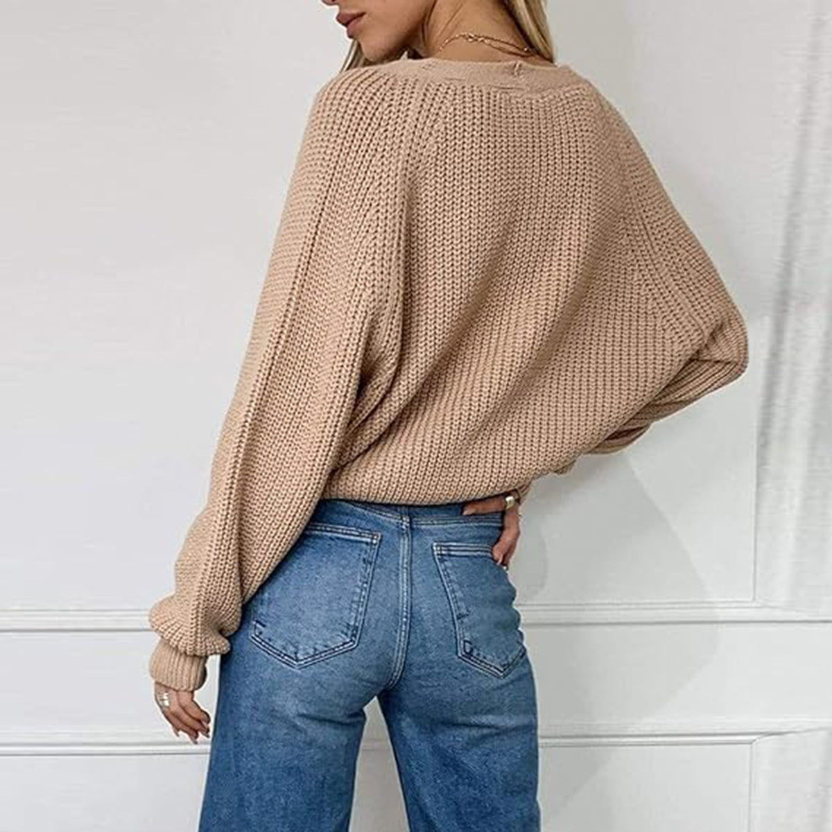 Tan ribbed knit cardigan with balloon sleeves and button details.