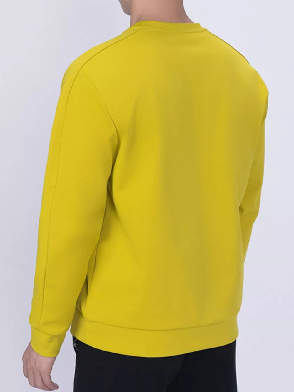 Yellow zippered sweatshirt with crew neck and long sleeves.