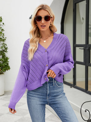 Purple cropped V-neck knit cardigan with button front and open knit detail.