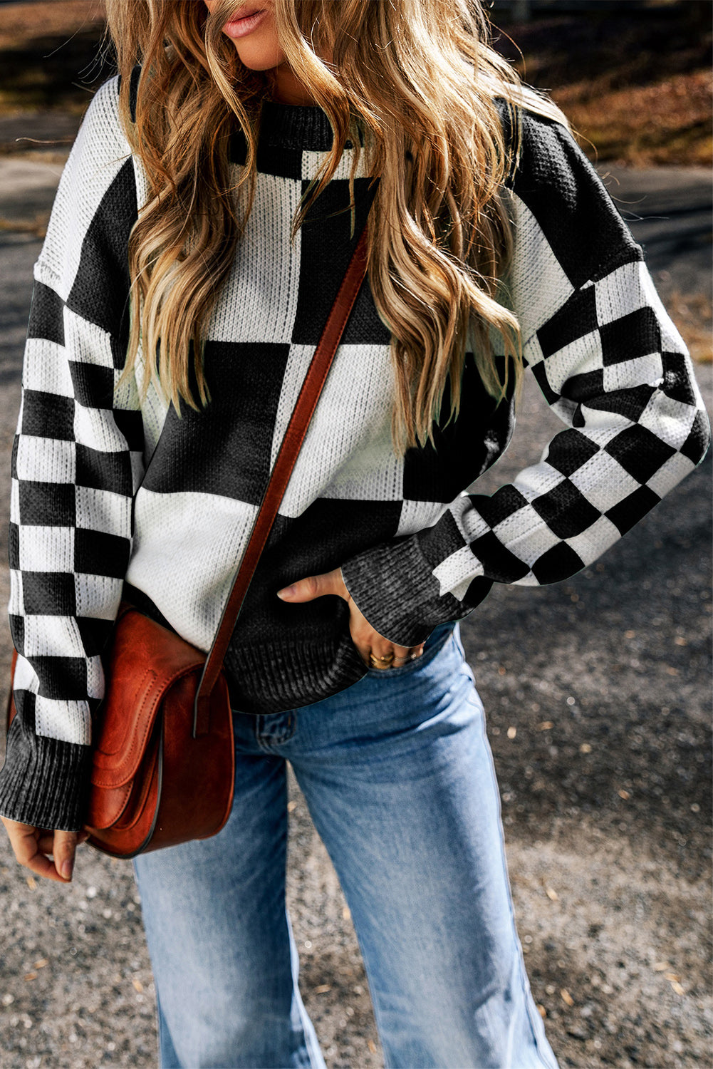 Colorblock checkerboard knit sweater in black and white acrylic with crew neck.