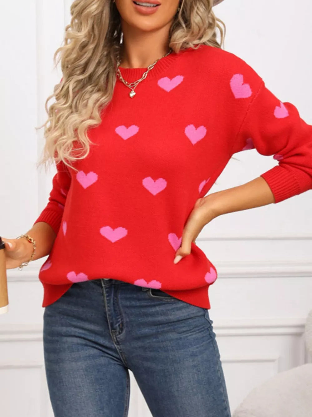 Rose red acrylic sweater with pink heart print, crew neck, and long sleeves.