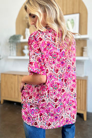 Pink ikat print relaxed fit v-neck blouse with short sleeves.