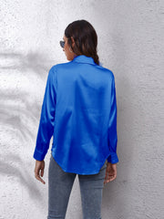 Royal blue silken button-down shirt with long sleeves and a relaxed fit.