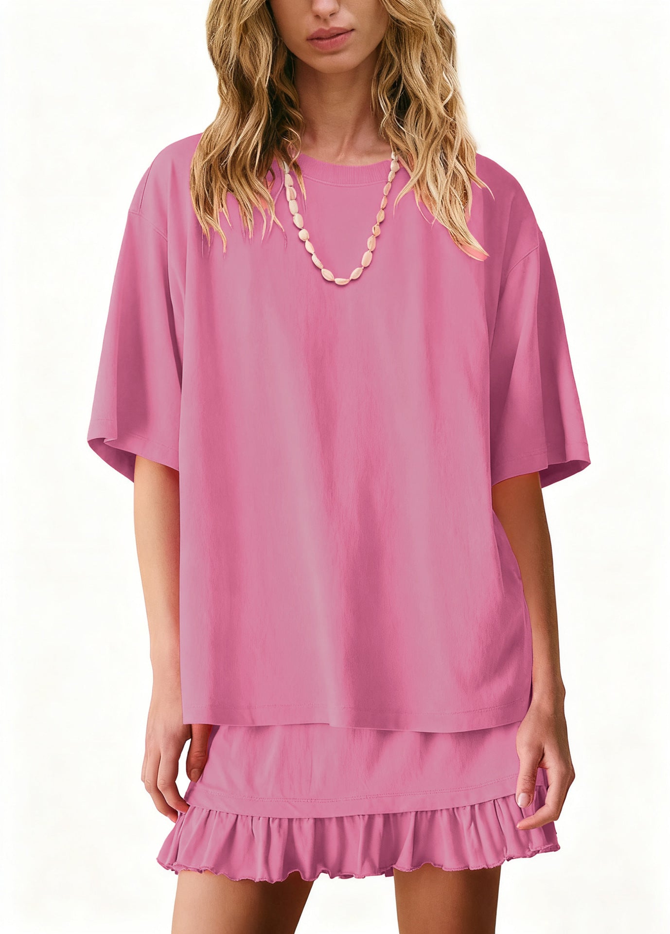 Light pink ruffled tee and skirt set with short sleeves and a crew neck.