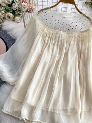 Apricot sheer blouse with rhinestone collar and feather trim.