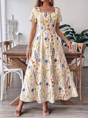 A-line maxi dress with square neckline and short sleeves in a cream floral print.