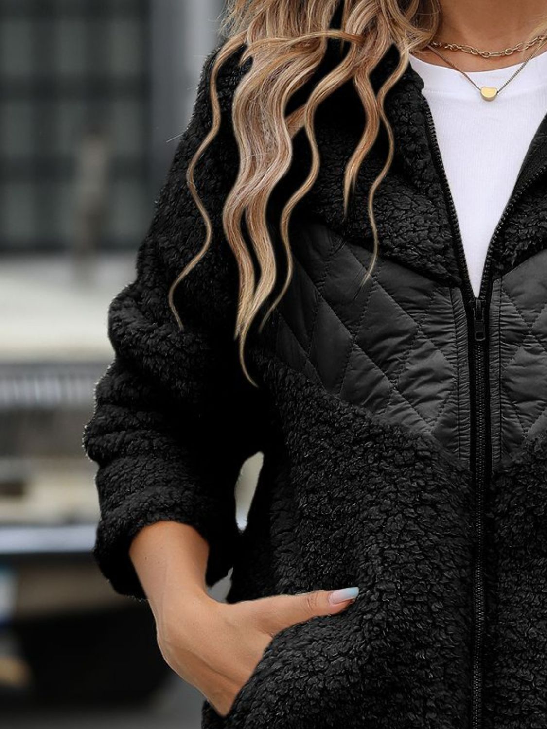 Black teddy hoodie with quilted panel detail and zip front.