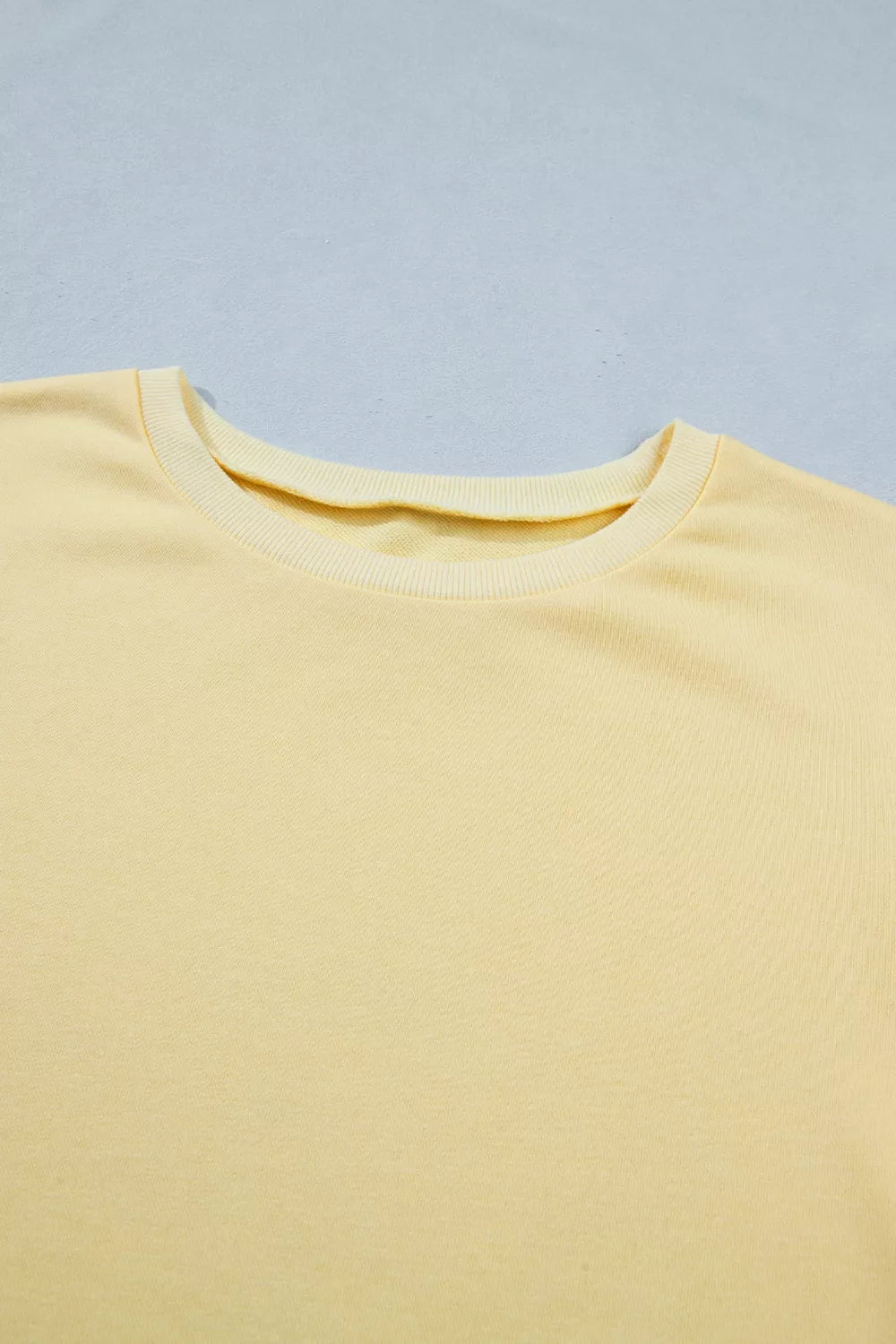 Yellow cotton half-sleeve top with crew neck detail
