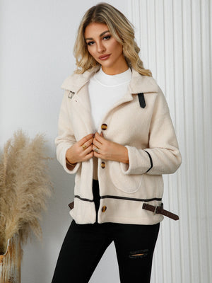 Teddy-textured jacket in cream with leatherette trim and buckle details.