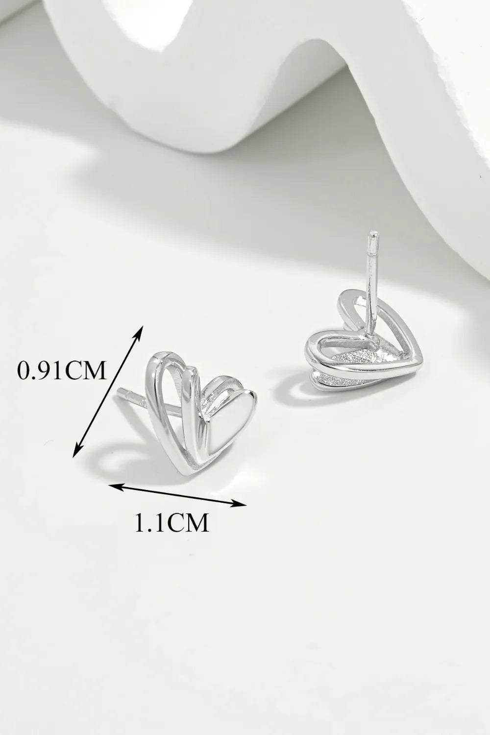 Silver open heart silhouette stud earrings with dimensions shown.