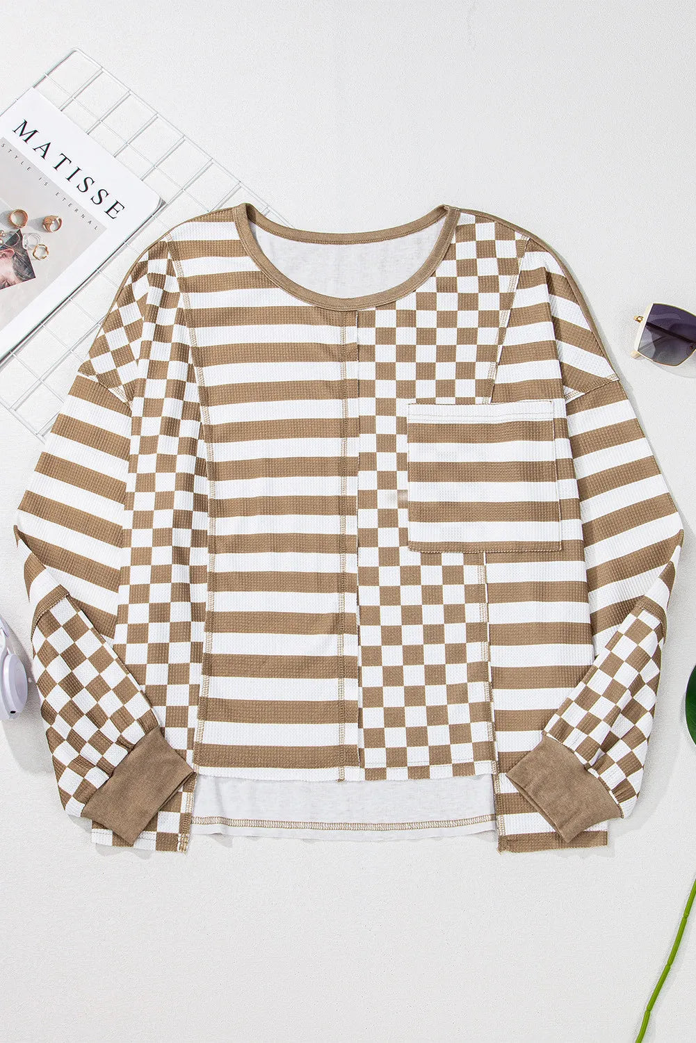 Camel and white checkered and striped patchwork knit top with long sleeves and a chest pocket.