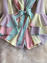 Color striped romper with tiered ruffles and a bow belt detail.