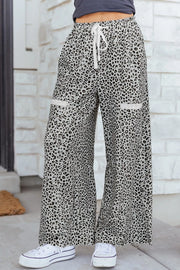 Animal print wide leg pants with drawstring waist and contrast trim pockets.