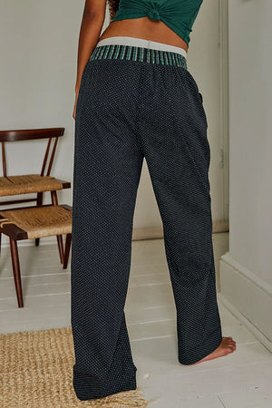 Black polka dot lounge trousers with a striped waistband