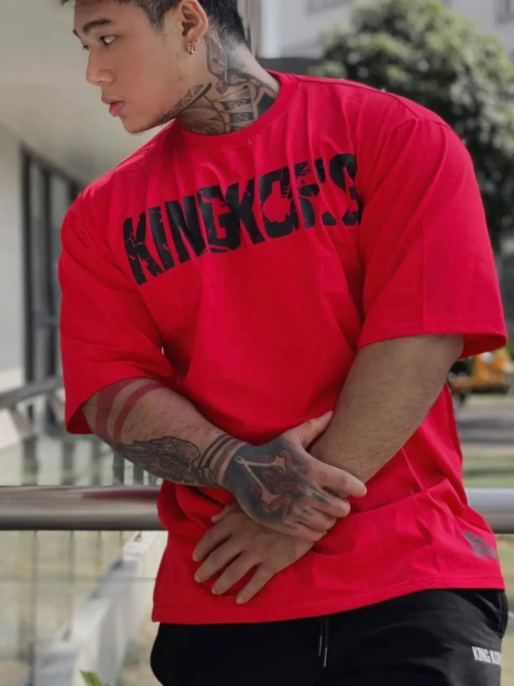 Red oversized graphic tee with black King Kong's text, short sleeves, and crew neck.