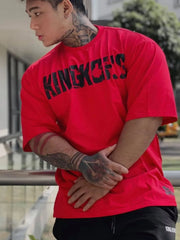 Red oversized graphic tee with black King Kong's text, short sleeves, and crew neck.
