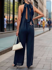 Dark blue halter wide leg jumpsuit with back tie detail and open back.