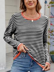 Black and white striped knit sweater with contrast coral trim and drop shoulders.