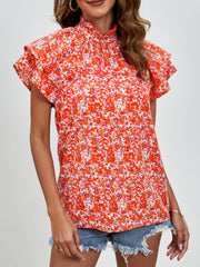 Orange floral blouse with ruffled neckline and flutter sleeves