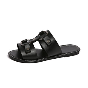 Black PU leather slide sandals with buckled straps and metal rings.