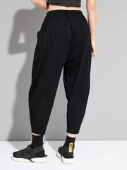 Black pinstripe harem maternity pants with elastic waist and pockets.