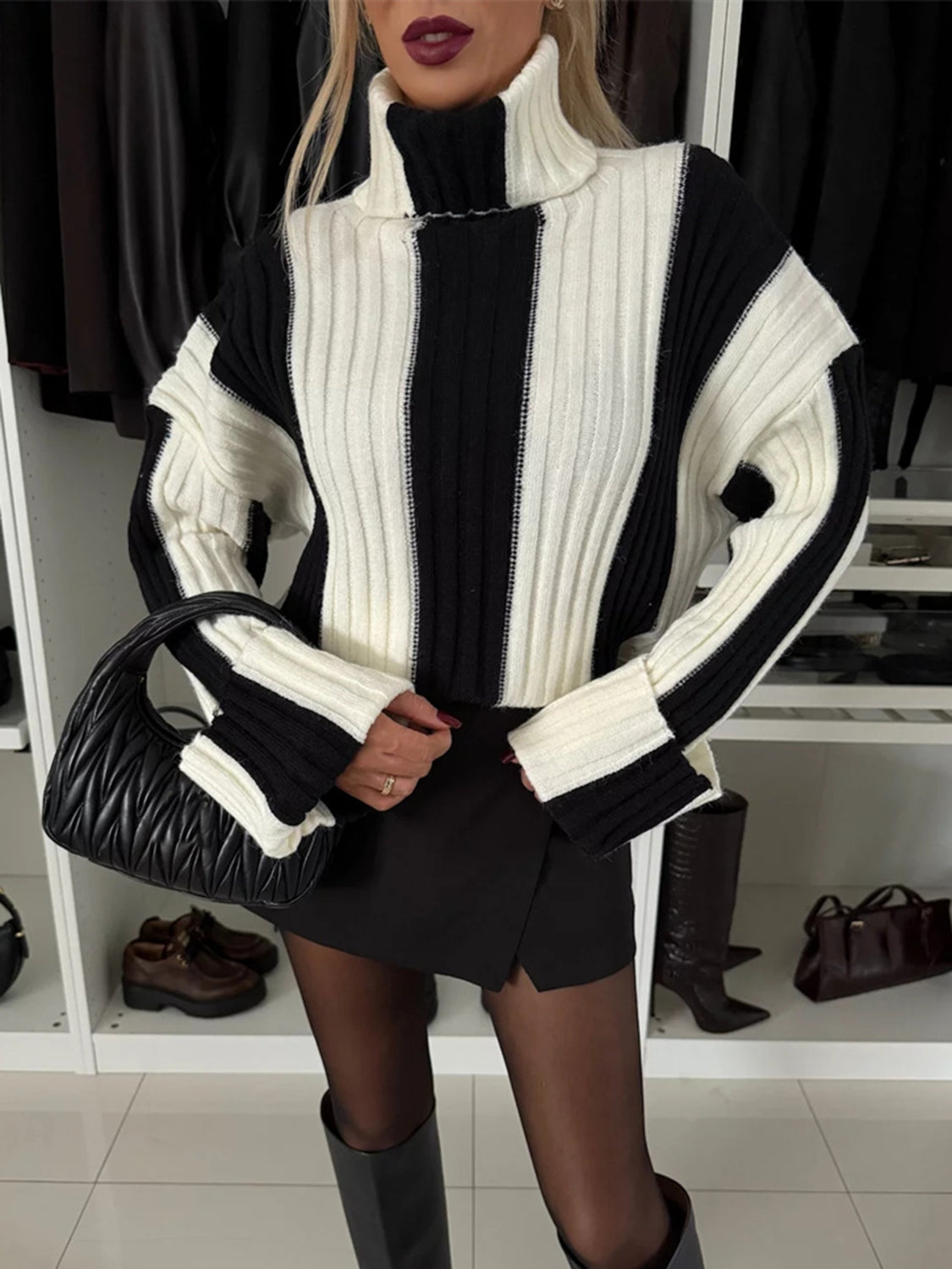 Bold stripe ribbed turtleneck sweater in black and white with a high neck.