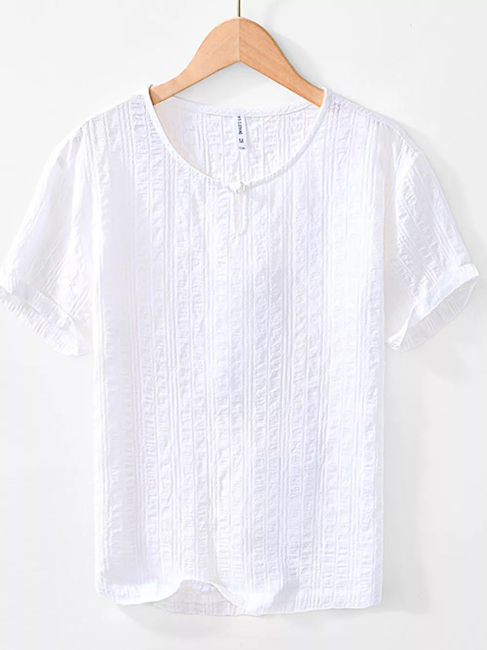 Men's white textured short sleeve cotton blouse with a button detail at the neckline.