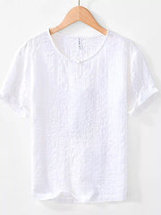 Men's white textured short sleeve cotton blouse with a button detail at the neckline.