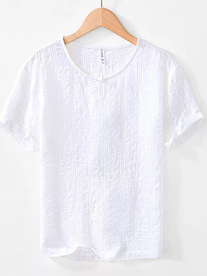 Men's white textured short sleeve cotton blouse with a button detail at the neckline.