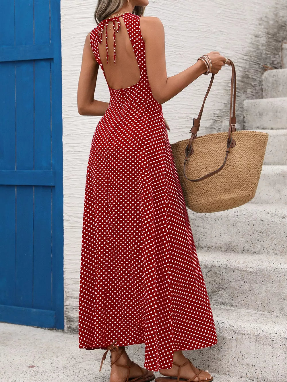 Deep red polka dot maxi dress with open back and tie detail.